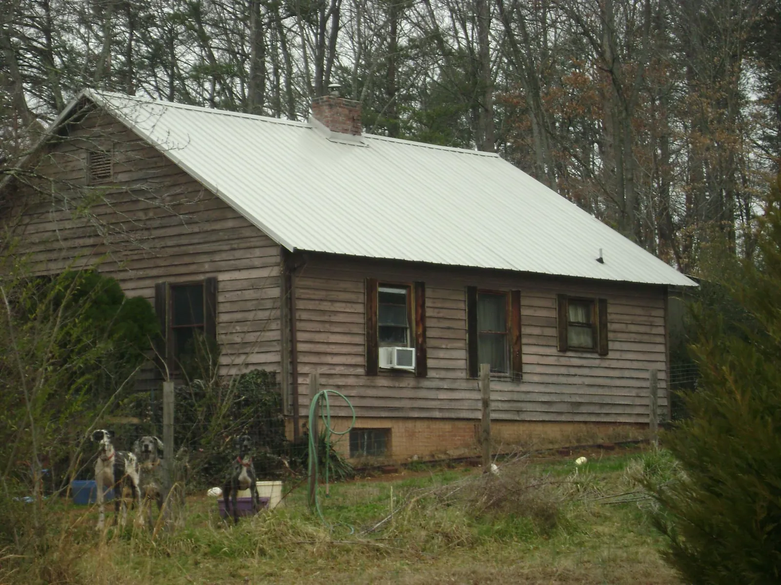 White metal roof on an old wood sided farmhouse, from a Metal Roof Installation job in Joint Base Mdl